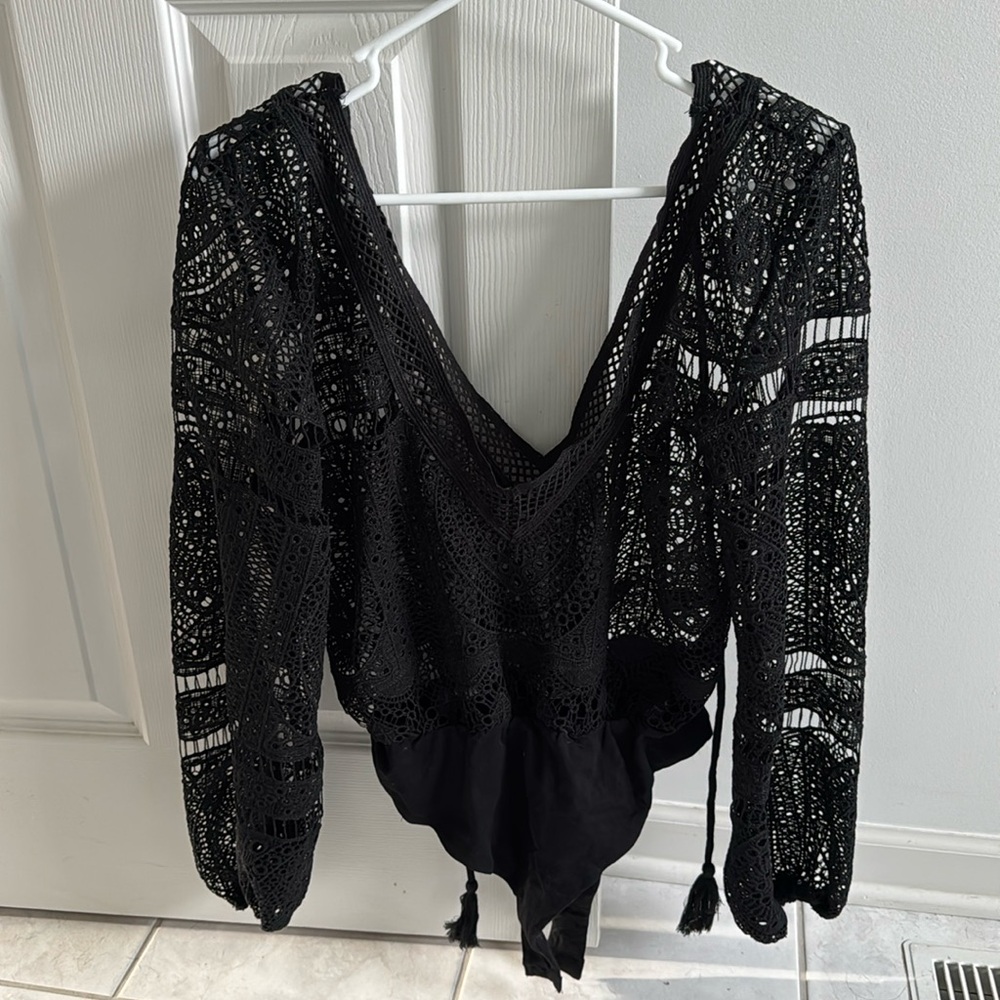 Never worn Blue Blush black lacey medium body suit loos fit on top.